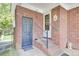 Brick entrance to home featuring a storm door and iron railing at 1237 Fort Dr, Hanahan, SC 29410