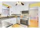 Bright kitchen with granite countertops, stainless steel appliances, and sunny yellow accents at 1237 Fort Dr, Hanahan, SC 29410