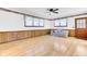 Bright, empty living room with wood paneling, hardwood floors, ceiling fan and couch at 1237 Fort Dr, Hanahan, SC 29410