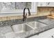 The kitchen features a sink beneath a window, set into a granite countertop at 1237 Fort Dr, Hanahan, SC 29410