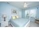 Comfortable bedroom with a ceiling fan, two windows dressed with white curtains, and a white-painted bed frame at 1253 Dingle Rd, Mount Pleasant, SC 29466