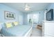 Comfortable bedroom with a ceiling fan, two windows dressed with white curtains, and a television at 1253 Dingle Rd, Mount Pleasant, SC 29466