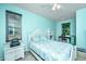 Bright bedroom featuring blue walls, and a window with blinds, complete with a ceiling fan at 1253 Dingle Rd, Mount Pleasant, SC 29466