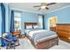 Inviting bedroom showcases a wood bed frame, matching furniture, and large windows with blue curtains at 1253 Dingle Rd, Mount Pleasant, SC 29466