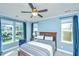 Comfortable bedroom featuring blue walls, a ceiling fan, and multiple windows for natural light at 1253 Dingle Rd, Mount Pleasant, SC 29466