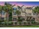 Charming townhome exterior with a beautiful landscape, garage, palm trees, and great curb appeal at 1253 Dingle Rd, Mount Pleasant, SC 29466
