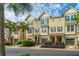 Charming townhomes with palm trees, lush shrubbery, covered front porches, and individual garages at 1253 Dingle Rd, Mount Pleasant, SC 29466