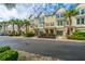 Exterior of charming townhomes with beautiful landscaping, palm trees, private garages, and street parking at 1253 Dingle Rd, Mount Pleasant, SC 29466