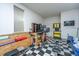 The well-lit garage has a checkered floor, exercise equipment, storage shelves, and a workspace at 1253 Dingle Rd, Mount Pleasant, SC 29466