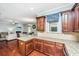 Bright kitchen features granite counters, wood cabinets, and an open layout to living and dining areas at 1253 Dingle Rd, Mount Pleasant, SC 29466