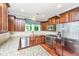 Beautiful kitchen boasts granite countertops, stainless steel appliances, and warm wood cabinetry at 1253 Dingle Rd, Mount Pleasant, SC 29466
