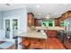 Granite countertops, cherry cabinets, an island, and stainless-steel appliances accent this kitchen at 1253 Dingle Rd, Mount Pleasant, SC 29466