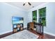 Office features a ceiling fan, a desk by the window, and a TV showing a beach at 1253 Dingle Rd, Mount Pleasant, SC 29466