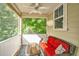 Relaxing screened porch with comfortable red seating, a glass coffee table, and serene wooded views at 1253 Dingle Rd, Mount Pleasant, SC 29466