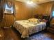 Bedroom with wood paneled walls, bed, small window, and a ceiling fan at 126 Rattlensnake Trl, Walterboro, SC 29488