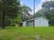 Exterior view of a small, light blue house with green trees surrounding it at 126 Rattlensnake Trl, Walterboro, SC 29488