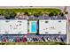Aerial view of buildings showcasing a community pool with several parking spaces available at 1400 Ocean Blvd # 106B, Isle of Palms, SC 29451