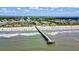 Beautiful aerial scene of a beachfront community featuring a pier, ocean, and buildings at 1400 Ocean Blvd # 106B, Isle of Palms, SC 29451