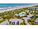 Beautiful beachfront with a pool and private cabana surrounded by palm trees and lush greenery at 1400 Ocean Blvd # 106B, Isle of Palms, SC 29451