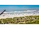 Enjoy stunning aerial view of a sandy beach with pier extending into the blue ocean at 1400 Ocean Blvd # 106B, Isle of Palms, SC 29451