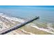 Breathtaking aerial view of a pier stretching out into the ocean, surrounded by waves at 1400 Ocean Blvd # 106B, Isle of Palms, SC 29451