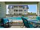 Balcony with comfortable seating, looking onto the pool and condominium building at 1400 Ocean Blvd # 106B, Isle of Palms, SC 29451