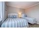 Comfortable bedroom with matching beds, coastal decor, and wood-look flooring at 1400 Ocean Blvd # 106B, Isle of Palms, SC 29451