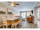 Comfortable living space with a dining table, cozy furniture, and a sliding door to the balcony at 1400 Ocean Blvd # 106B, Isle of Palms, SC 29451