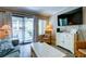 The living room offers comfortable seating, a television and access to the exterior deck at 1400 Ocean Blvd # 106B, Isle of Palms, SC 29451