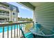 Relaxing patio area with outdoor seating overlooking a sparkling pool at 1400 Ocean Blvd # 106B, Isle of Palms, SC 29451