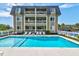 Beautiful condominium complex featuring a large shimmering pool with ample space for sunbathing and relaxation at 1400 Ocean Blvd # 106B, Isle of Palms, SC 29451