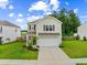 Charming two-story home featuring neutral siding, an attached garage, and a well-manicured lawn at 141 Sweet Cherry Ln, Summerville, SC 29486