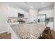 Bright kitchen features stainless steel appliances, granite countertops, and white cabinets at 141 Sweet Cherry Ln, Summerville, SC 29486
