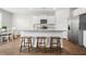 Modern kitchen with granite countertops, stainless steel appliances, and bar stool seating; dining area nearby at 141 Sweet Cherry Ln, Summerville, SC 29486