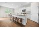 Bright kitchen with white cabinets, granite countertops, and breakfast bar seating open to the dining area at 141 Sweet Cherry Ln, Summerville, SC 29486