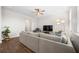 Bright living room featuring a large sectional sofa, a TV, and hardwood floors, creating a cozy atmosphere at 141 Sweet Cherry Ln, Summerville, SC 29486