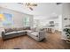 Open-concept living area flows into the kitchen and dining space with a large sectional sofa and modern finishes at 141 Sweet Cherry Ln, Summerville, SC 29486