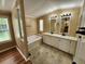 Bathroom featuring dual sinks, plentiful counter space, a soaking tub, and a window for natural light at 149 Old Red Hill Rd, Ridgeville, SC 29472