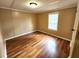 Cozy bedroom with hardwood floors, neutral paint, and a window, providing a calm and comfortable retreat at 149 Old Red Hill Rd, Ridgeville, SC 29472