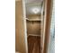 Functional closet with a sturdy shelf, clothes rod, and wood flooring, providing efficient storage space at 149 Old Red Hill Rd, Ridgeville, SC 29472