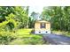 Cozy single-story home featuring light siding, a simple porch, and a shingled roof, nestled in a verdant, wooded setting at 149 Old Red Hill Rd, Ridgeville, SC 29472