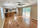 Open-concept living space with hardwood floors, bar seating, and sliding glass doors leading to an outdoor deck at 149 Old Red Hill Rd, Ridgeville, SC 29472