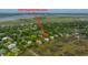 An aerial view shows the property located on a lush street with marsh and river views at 1520 Regimental Ln, Johns Island, SC 29455