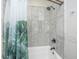 Bright bathroom featuring a marble tile shower and tub with matte black hardware at 1520 Regimental Ln, Johns Island, SC 29455