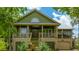 Charming two-story home with a welcoming front porch and lush landscaping at 1520 Regimental Ln, Johns Island, SC 29455