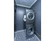 Modern laundry room with a stacked washer and dryer and patterned flooring at 1520 Regimental Ln, Johns Island, SC 29455