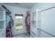 This walk-in closet has custom storage, a window, and hardwood floors at 1520 Regimental Ln, Johns Island, SC 29455