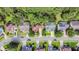 An aerial view showing a residential street, lush landscaping, and mature trees at 1664 William Hapton Way, Mount Pleasant, SC 29466