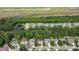 An aerial view of a residential area with houses, lush landscaping, and a pond at 1664 William Hapton Way, Mount Pleasant, SC 29466