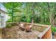 Relaxing back deck with comfortable seating, surrounded by lush trees at 1664 William Hapton Way, Mount Pleasant, SC 29466